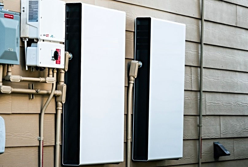 Happy family in front of their home with solar panels